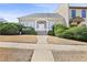 Charming home with a well-manicured front yard and a stately entrance featuring an arched doorway at 9390 Knollcrest, Alpharetta, GA 30022
