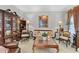 Cozy living room with classic furniture, a large display cabinet, and ample natural light at 9390 Knollcrest, Alpharetta, GA 30022