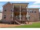 A well-maintained brick house boasts dual wooden decks overlooking a manicured lawn at 4930 Cecilia Sq, Cumming, GA 30040