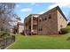 Well-kept lawn, fence, and a brick house with dual wooden decks in its backyard at 4930 Cecilia Sq, Cumming, GA 30040
