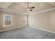 Spacious bedroom with tray ceiling, ceiling fan and neutral carpet at 4930 Cecilia Sq, Cumming, GA 30040
