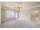 Spacious bedroom with neutral tones, ceiling fan, and door to outdoor balcony at 4930 Cecilia Sq, Cumming, GA 30040