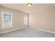 Carpeted bedroom featuring two large windows letting in natural light at 4930 Cecilia Sq, Cumming, GA 30040