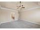 Large bedroom with ceiling fan shows doorway to en-suite bathroom at 4930 Cecilia Sq, Cumming, GA 30040