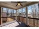 Exterior view of covered deck with railing showcasing a wooded backyard at 4930 Cecilia Sq, Cumming, GA 30040