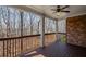 Covered deck with ceiling fan, brick wall, and wood railing at 4930 Cecilia Sq, Cumming, GA 30040