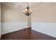 Elegant dining room featuring decorative trim, hardwood floors, and a chandelier, perfect for gatherings at 4930 Cecilia Sq, Cumming, GA 30040