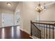 Foyer with hardwood floors, chandelier, staircase and lots of light at 4930 Cecilia Sq, Cumming, GA 30040
