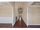 Spacious hallway with gleaming hardwood floors, elegant trim, and sophisticated lighting fixtures at 4930 Cecilia Sq, Cumming, GA 30040