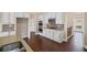 Gourmet kitchen featuring stainless steel appliances, granite countertops, and sleek white cabinetry at 4930 Cecilia Sq, Cumming, GA 30040