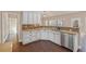 Bright kitchen featuring stainless steel appliances, large sink, and open layout to living area at 4930 Cecilia Sq, Cumming, GA 30040