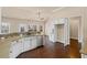 Open kitchen layout with stainless appliances, granite counters, breakfast bar, and abundant natural light at 4930 Cecilia Sq, Cumming, GA 30040