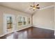 Bright living room with windows to deck, hardwood floors, natural light, and a ceiling fan at 4930 Cecilia Sq, Cumming, GA 30040