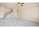 Open living room with neutral carpet and stairs in the background at 4930 Cecilia Sq, Cumming, GA 30040