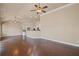 Spacious living room with hardwood floors and an open concept to the kitchen and dining area at 4930 Cecilia Sq, Cumming, GA 30040