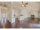 Open-concept living area boasting hardwood floors, stone fireplace, and seamless flow to the kitchen at 4930 Cecilia Sq, Cumming, GA 30040