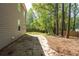 Spacious backyard with a concrete patio, mature trees, and a wooden fence at 5330 Willow Park Blvd, Atlanta, GA 30349