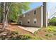 Two-story home with backyard patio, set amongst lush trees and green foliage at 5330 Willow Park Blvd, Atlanta, GA 30349