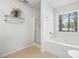 Bright bathroom featuring a soaking tub, window, and glass shower, combining relaxation with natural light at 5330 Willow Park Blvd, Atlanta, GA 30349