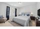 Comfortable bedroom features a bed with blue pillows, a plush chair, and abundant natural light for relaxation at 5330 Willow Park Blvd, Atlanta, GA 30349