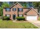 Charming two-story brick home featuring a well-maintained lawn and a two-car garage at 5330 Willow Park Blvd, Atlanta, GA 30349