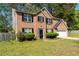 Charming two-story brick home featuring a manicured lawn and traditional black shutters at 5330 Willow Park Blvd, Atlanta, GA 30349