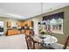 A kitchen featuring wooden cabinets, stainless steel appliances, and a dining area with a large window at 5330 Willow Park Blvd, Atlanta, GA 30349