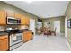 Functional kitchen with stainless steel appliances, light tile floors, and an adjacent dining area at 5330 Willow Park Blvd, Atlanta, GA 30349