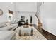 Bright living room features a high ceiling, hardwood floors, and a comfortable gray sofa at 5330 Willow Park Blvd, Atlanta, GA 30349