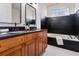 Elegant bathroom with double sink vanity, granite countertop, and soaking tub at 970 Welch Sw St, Atlanta, GA 30310