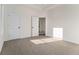 Bright bedroom with neutral carpet and trim, featuring a tray ceiling and natural light at 970 Welch Sw St, Atlanta, GA 30310