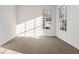 Bright, carpeted bedroom bathed in natural light from a pair of large windows at 970 Welch Sw St, Atlanta, GA 30310