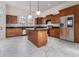 Modern kitchen with a central island, stainless appliances, and marble tile at 970 Welch Sw St, Atlanta, GA 30310