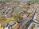 Aerial view of a beautiful neighborhood with a pond, walking trails, and lush greenery at 184 Cadence Trl, Canton, GA 30115