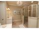 Elegant bathroom featuring a glass shower, crystal chandelier, and a vanity with marble countertops at 184 Cadence Trl, Canton, GA 30115