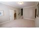 Neutral bedroom featuring neutral walls and carpet, with a doorway to a carpeted staircase at 184 Cadence Trl, Canton, GA 30115