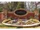 Cadence Woodmont Golf and Country Club's brick entrance sign is accented with vibrant flower beds at 184 Cadence Trl, Canton, GA 30115