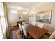 Inviting dining area featuring a chandelier, plantation shutters, and neutral paint at 184 Cadence Trl, Canton, GA 30115