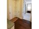 Hallway with hardwood floors, white trim, and access to a bright room with large windows at 184 Cadence Trl, Canton, GA 30115