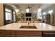 Kitchen island features quartz countertop and stainless steel sink open to the living room at 184 Cadence Trl, Canton, GA 30115