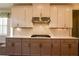 Kitchen boasts custom cabinets, quartz countertops, stainless steel appliances, and modern backsplash at 184 Cadence Trl, Canton, GA 30115