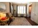 Inviting office with soft rug, desk, and windows to bring the outdoors in at 184 Cadence Trl, Canton, GA 30115