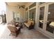 Relaxing outdoor patio with comfortable wicker furniture and views of the manicured yard at 184 Cadence Trl, Canton, GA 30115
