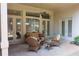 Inviting patio featuring outdoor seating, ceiling fan, and views of the landscaped backyard at 184 Cadence Trl, Canton, GA 30115