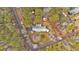 An aerial perspective shows the house, driveway, and surrounding wooded area within the property at 303 Fireside Trl, Douglasville, GA 30134
