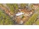 An aerial view captures the property's layout, including landscaping and proximity to surrounding trees at 303 Fireside Trl, Douglasville, GA 30134
