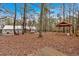 View of the backyard with a wooden deck and a covered gazebo, perfect for outdoor entertaining at 303 Fireside Trl, Douglasville, GA 30134