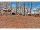 A spacious backyard features a wooden gazebo and a metal carport for outdoor activities and storage at 303 Fireside Trl, Douglasville, GA 30134