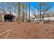 Spacious backyard with metal carport and storage shed providing ample space and storage options at 303 Fireside Trl, Douglasville, GA 30134