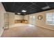 Spacious basement with dark ceiling, carpet, tile floor, a countertop, cabinets and French doors at 303 Fireside Trl, Douglasville, GA 30134